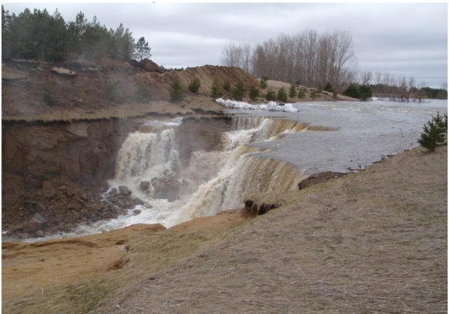 Severe Auxiliary Spillway Erosion, Because auxiliary spillways are not designed to convey flow regularly and are typically constructed in natural soils, they often exhibit some level of erosion when activated. A small amount of irregularity on the auxiliary spillway slope may be enough to concentrate flow and can create substantial erosion.