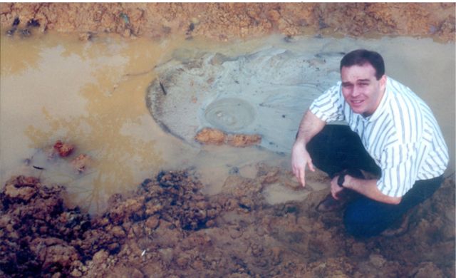 Boil at the Toe of an Embankment Dam, Active boils usually occur within 10 to 300 feet from the downstream toe of the dam and, in some instances, have occurred up to 1,000 feet away. A photograph showing a boil at the downstream toe of an embankment dam is presented. When material is carried upward through a boil, it is deposited in a circular pattern around the exit location, and appears comparable to an ant hill or volcano.